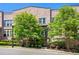 Charming townhome featuring a brick facade, manicured landscaping, and a private balcony at 57 Weston Dr # 13, Atlanta, GA 30328