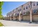 Street view of brick townhomes featuring attached garages and private balconies at 57 Weston Dr # 13, Atlanta, GA 30328