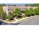 Landscaped brick townhome complex with a sidewalk and lush trees on a sunny day at 57 Weston Dr # 13, Atlanta, GA 30328