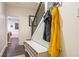 Welcoming hallway with a staircase, bench, and colorful outerwear hanging on hooks at 57 Weston Dr # 13, Atlanta, GA 30328