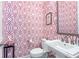 Charming powder room showcasing vibrant pink patterned wallpaper and modern fixtures at 57 Weston Dr # 13, Atlanta, GA 30328