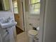 Classic bathroom with traditional fixtures, a pedestal sink, and hexagon tile flooring at 4589 Mesaview Way, Stone Mountain, GA 30083