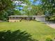 Charming brick home featuring a well-manicured lawn, mature trees, and a two-car garage at 4589 Mesaview Way, Stone Mountain, GA 30083