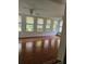 Bright sun room filled with natural light from many windows and hardwood flooring at 4589 Mesaview Way, Stone Mountain, GA 30083
