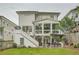 Spacious backyard featuring a modern two-story home with a covered patio, hot tub, and staircase at 1059 Antioch Dr, Brookhaven, GA 30319