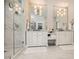 Bright bathroom featuring dual vanities, large mirrors, a glass-enclosed shower, and tile flooring at 1059 Antioch Dr, Brookhaven, GA 30319