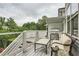 Outdoor deck with built-in grill and seating area with wooded views at 1059 Antioch Dr, Brookhaven, GA 30319