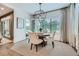 Cozy dining area with modern lighting, stylish chairs, a rustic table, and views of outdoor greenery at 1059 Antioch Dr, Brookhaven, GA 30319