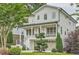 Beautifully landscaped two-story home with a cozy front porch and a two-car garage at 1059 Antioch Dr, Brookhaven, GA 30319