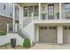 Close up on the front exterior featuring a charming porch and a two-car garage at 1059 Antioch Dr, Brookhaven, GA 30319