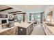 Open-concept kitchen with island seating flows to the living area, featuring stainless appliances and abundant natural light at 1059 Antioch Dr, Brookhaven, GA 30319