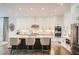 Beautiful kitchen with white cabinets, stainless steel appliances, large island with seating and hardwood floors at 1059 Antioch Dr, Brookhaven, GA 30319