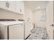 Bright laundry room with patterned tile floor, modern washer, dryer and sink at 1059 Antioch Dr, Brookhaven, GA 30319