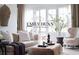 Bright living room with neutral decor, stylish furniture, and French doors opening to the outside at 1059 Antioch Dr, Brookhaven, GA 30319