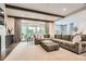 Spacious living room featuring a large sectional sofa, beams, and lots of natural light at 1059 Antioch Dr, Brookhaven, GA 30319