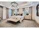 Spacious main bedroom with a tufted headboard, stylish chandelier, sitting area, and patterned carpet at 1059 Antioch Dr, Brookhaven, GA 30319