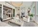 Bright sun room featuring white shiplap walls, modern lighting, fireplace, comfortable seating and access to the backyard at 1059 Antioch Dr, Brookhaven, GA 30319