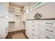 Well-organized walk-in closet with custom shelving, drawers, wood floor and a window for natural light at 1059 Antioch Dr, Brookhaven, GA 30319