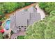 Aerial view of the house with a pool, deck, and patio, surrounded by tall mature trees at 176 Nightwind Trce, Acworth, GA 30101