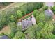 Aerial view of a home with a backyard pool, surrounded by mature trees, and golf course in the background at 176 Nightwind Trce, Acworth, GA 30101