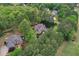 Aerial view showcasing the home nestled among mature trees, and a pool in the backyard at 176 Nightwind Trce, Acworth, GA 30101