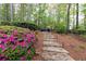 Picturesque backyard with stone steps, mature plantings and a fire pit area perfect for entertaining at 176 Nightwind Trce, Acworth, GA 30101