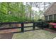 Fenced-in backyard, mulch, well maintained lawn and wooded backdrop at 176 Nightwind Trce, Acworth, GA 30101