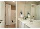 Bright bathroom with shower/tub combo, white vanity and a large mirror at 176 Nightwind Trce, Acworth, GA 30101