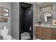 Beautiful bathroom features modern tile shower, wooden vanity, and round mirror at 176 Nightwind Trce, Acworth, GA 30101