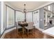 An eat-in kitchen features hardwood floors, grey walls, and a breakfast nook with large windows and natural light at 176 Nightwind Trce, Acworth, GA 30101