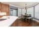 An eat-in kitchen features hardwood floors, wood cabinets, modern countertops, and a breakfast nook with natural light at 176 Nightwind Trce, Acworth, GA 30101