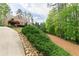 A long driveway leading to a home with an American flag and mature landscaping at 176 Nightwind Trce, Acworth, GA 30101