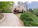 Long driveway leading up to a home with an American flag and mature landscaping surrounding the property at 176 Nightwind Trce, Acworth, GA 30101