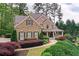 Beautiful brick home with manicured landscaping, shutters, and an American flag on the porch at 176 Nightwind Trce, Acworth, GA 30101