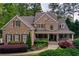 Charming brick home with a welcoming front porch, well-manicured landscaping, and classic architectural details at 176 Nightwind Trce, Acworth, GA 30101