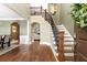 Elegant foyer with hardwood floors, staircase with iron railings, and views into the living and dining areas at 176 Nightwind Trce, Acworth, GA 30101