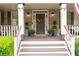 Close-up of the front door with decorative wreath, surrounded by potted plants and a charming front porch at 176 Nightwind Trce, Acworth, GA 30101
