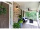 Cozy front porch with comfortable seating area, ceiling fan, and view of the beautifully landscaped yard at 176 Nightwind Trce, Acworth, GA 30101