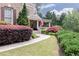 Charming home with beautiful landscaping, a walkway and an American flag on the front porch at 176 Nightwind Trce, Acworth, GA 30101