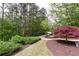 Circular drive with well manicured lawn, wooded backdrop and decorative red maple at 176 Nightwind Trce, Acworth, GA 30101