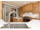 The kitchen features a large sink, modern countertops, wooden cabinets, stainless steel appliances, and a view into another room at 176 Nightwind Trce, Acworth, GA 30101