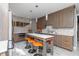 Spacious kitchen with wood cabinets, stone backsplash, and marble island with seating at 176 Nightwind Trce, Acworth, GA 30101