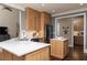 Modern kitchen with a center island, wooden cabinets, stainless steel appliances, and a view into another room at 176 Nightwind Trce, Acworth, GA 30101