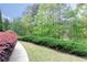 Well-maintained landscaping with lush shrubs and green grass bordering a curved walkway at 176 Nightwind Trce, Acworth, GA 30101