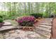 Stone walkway and lush landscaping leading to the backyard at 176 Nightwind Trce, Acworth, GA 30101