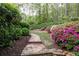 Stone path through landscaped garden featuring azaleas and manicured greenery at 176 Nightwind Trce, Acworth, GA 30101