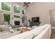 Comfortable living room with a wall of large windows, a fireplace, and a ceiling fan at 176 Nightwind Trce, Acworth, GA 30101