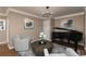 Cozy living room featuring an upright piano, crown molding, and designer decor at 176 Nightwind Trce, Acworth, GA 30101