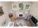 Aerial view of a living room with tall windows, a fireplace, and comfortable furnishings at 176 Nightwind Trce, Acworth, GA 30101