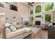 Bright, airy living room with tall windows, a fireplace, and a second-story balcony at 176 Nightwind Trce, Acworth, GA 30101